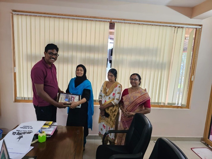 Ms. Shehan V. K., Administrative Officer, being honored during her farewell event. Dr. Suresh C. H., Director of SRIBS, presenting a memento.